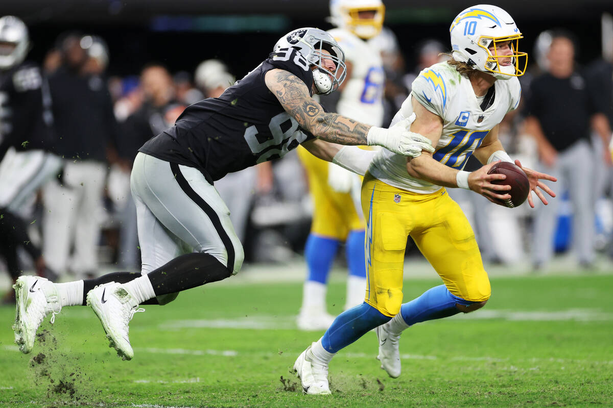 Raiders defensive end Maxx Crosby (98) misses a tackle on Los Angeles Chargers quarterback Just ...