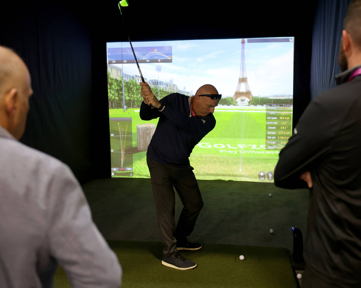 Lamar Gibson of Memphis, Tenn. tries out the Golfzon Vision golf simulator on opening day of CE ...