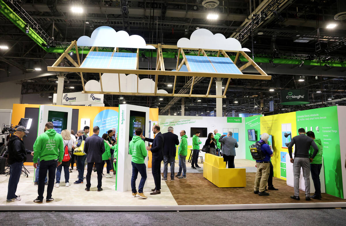 Conventioneers check out Schneider Electric smart home devices on opening day of CES at Venetia ...