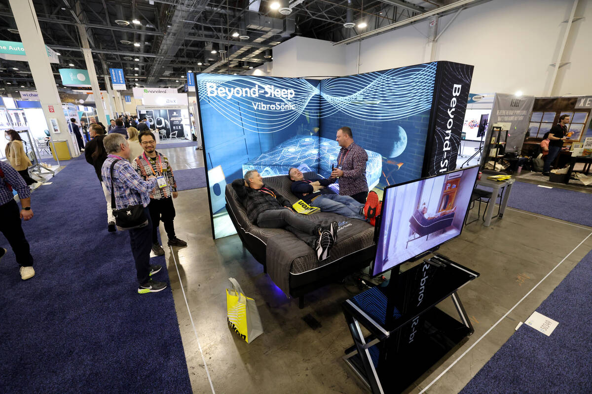 Robert Eskridge shows Nate Oldham of Vineyard, Utah, left, and Chad Williams of Orem, Utah. a B ...