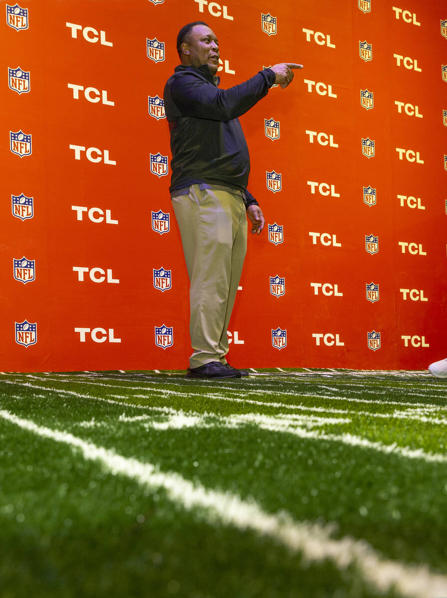 NFL Football legend Barry Sanders awaits the next attendee at a meet-and-greet sponsored by TCL ...