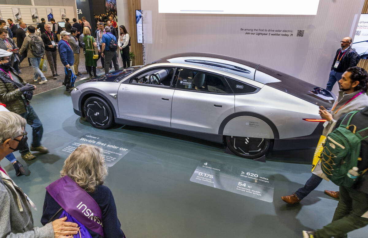 Attendees check out the Lightyear 0 solar electric vehicle during the opening day of CES 2023 ...