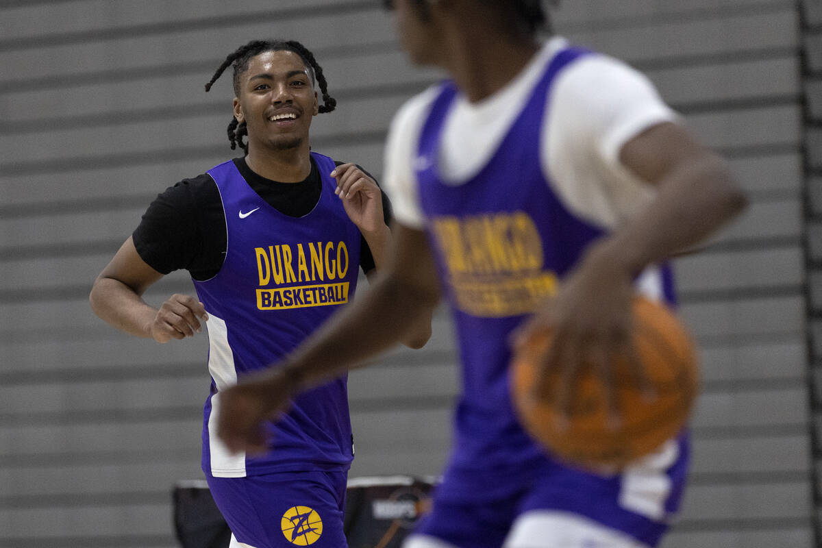 Durango’s Taj Degourville, left, laughs with teammate Tylen Riley, right, during a boys high ...