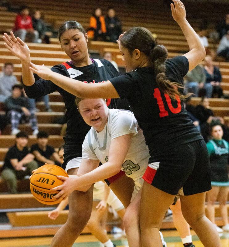 Green Valley's Amelia Rawhouser (30) is sandwiched between Liberty High's defenders, including ...