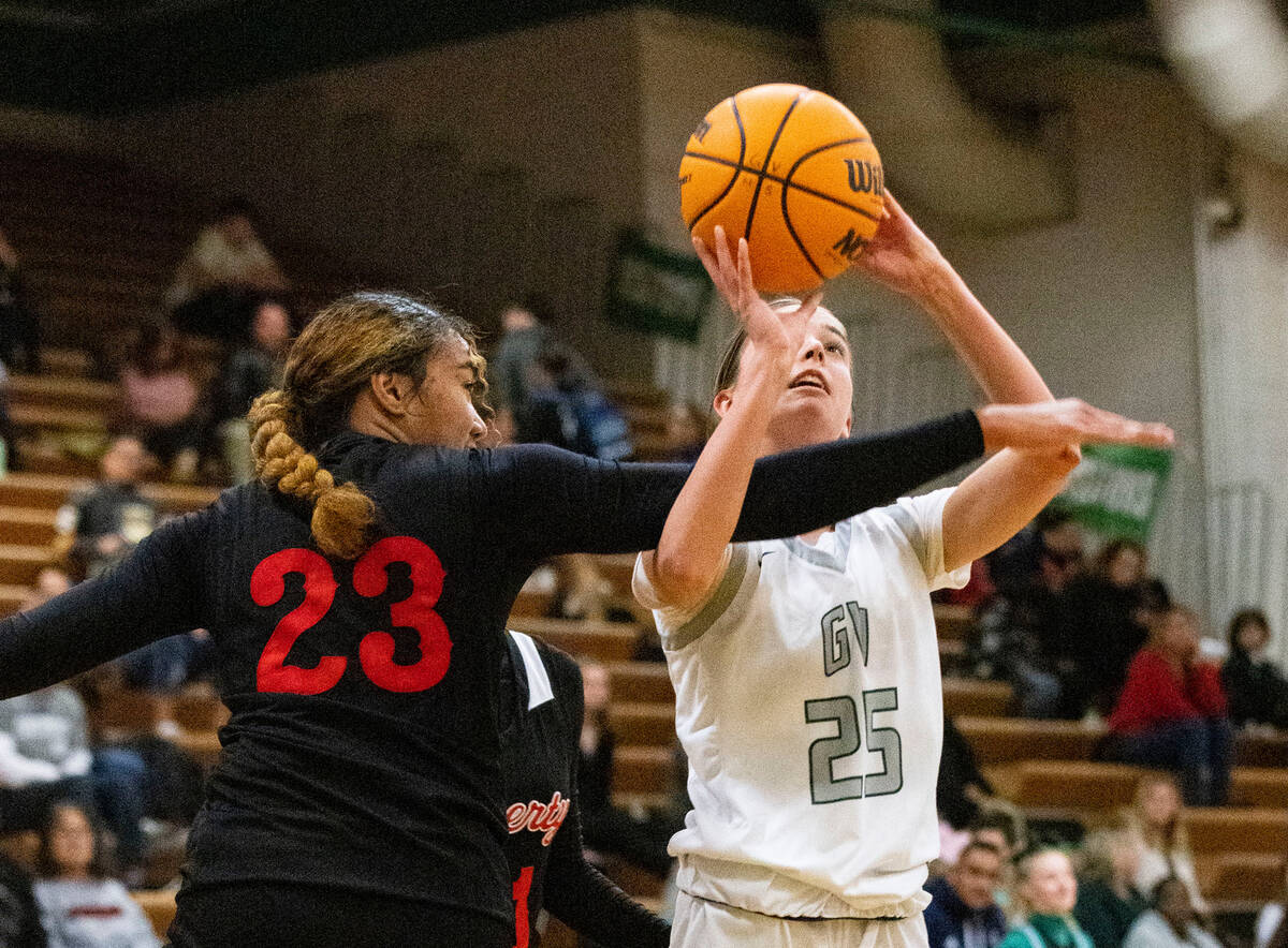 Green Valley's Kyra Willey (25) shoots for the basket as Liberty High's Adrienne Puletasi (2 ...