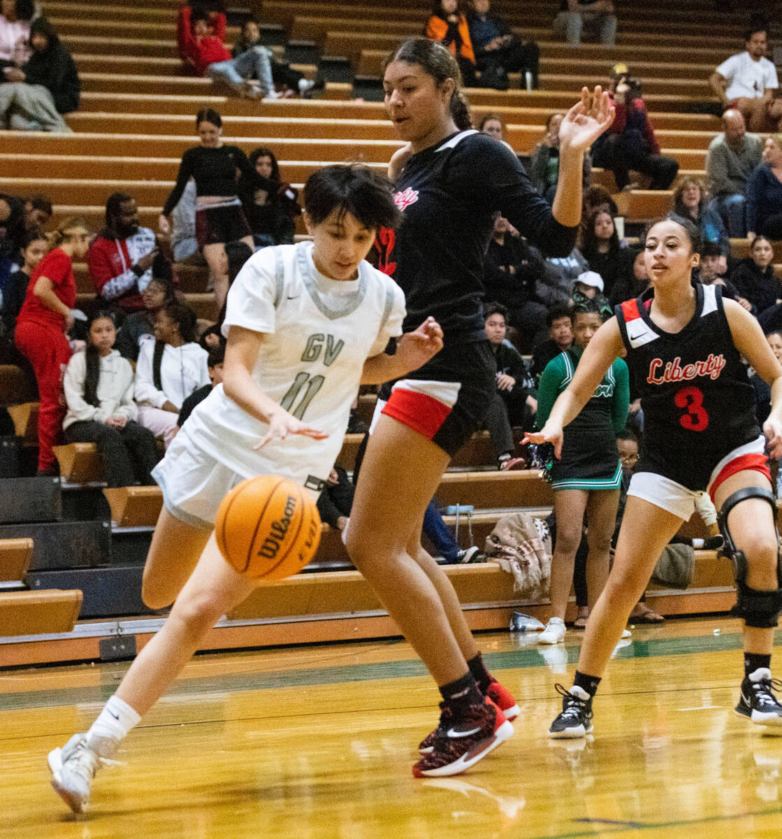 Green Valley's Jaelen Lautenslager (11) drives past Liberty High's Daisha Peavy (12) during the ...