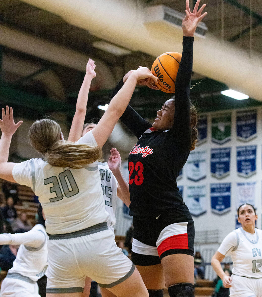 Green Valley High's Amelia Rawhouser (30) blocks Liberty High's Adrienne Puletasi (23) shot dur ...