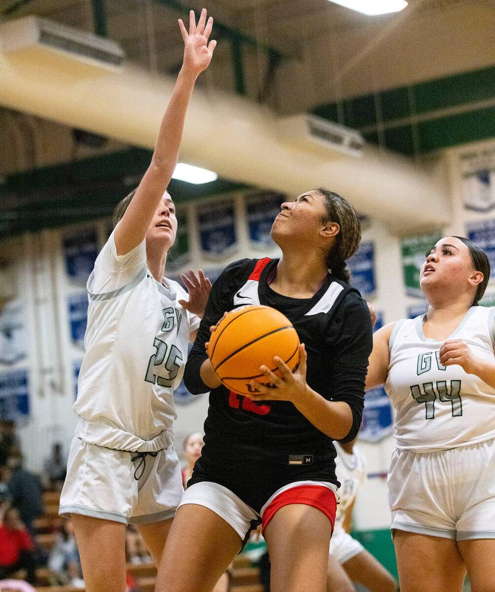 Green Valley's Kyra Willey (25) and Saedy Cozo (44) defend Liberty High's Daisha Peavy (12) dur ...