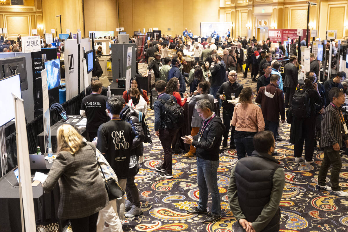 People attend CES ShowStoppers event at the Bellagio hotel-casino in Las Vegas, Thursday, Jan. ...