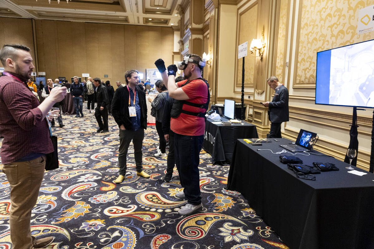 Attendees watch a demonstration of the bHaptics TactSuit during the CES ShowStoppers event at t ...