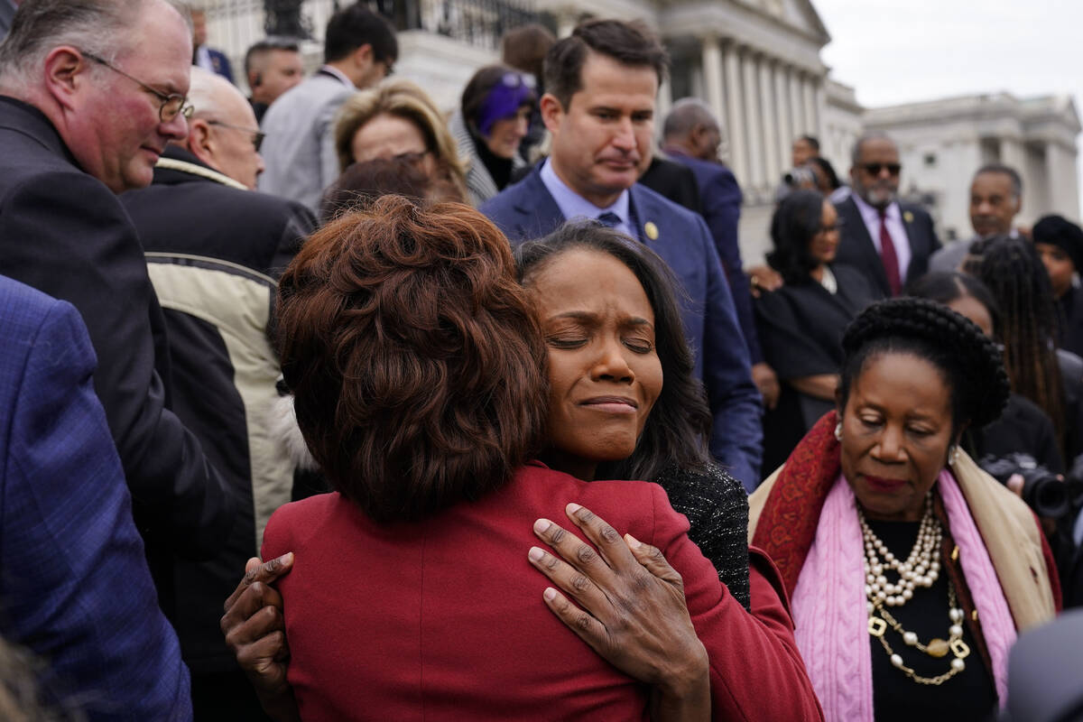 Serena Liebengood, center right, widow of U.S. Capitol Police officer Howard Liebengood, embrac ...