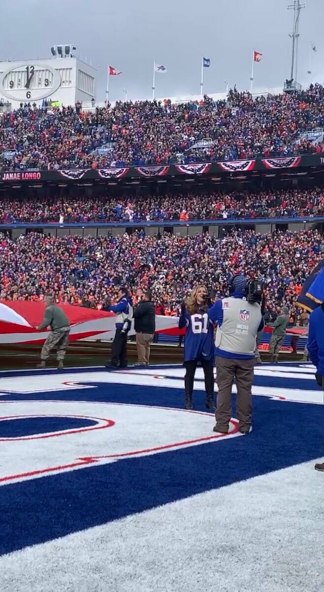Las Vegas entertainer Janae Longo sings the national anthem at then-New Era Field (today's High ...