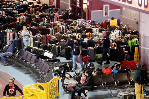 Workers looks for passengers’ luggage from canceled and delayed flights in the Southwest bagg ...