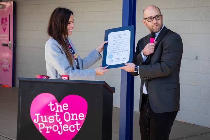 Brooke Neubauer, left, founder and CEO of The Just One Project, accepts a proclamation from Cou ...