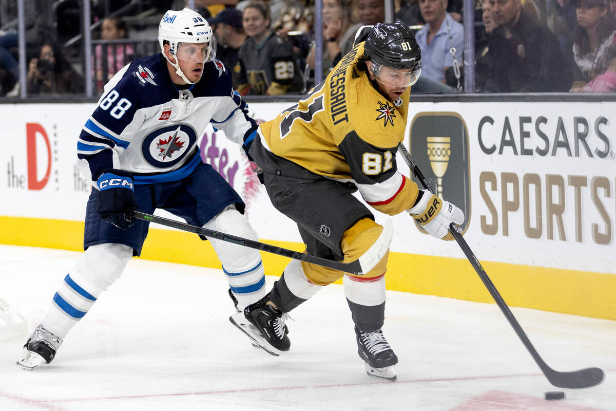 Golden Knights center Jonathan Marchessault (81) skates with the puck followed by Jets defensem ...