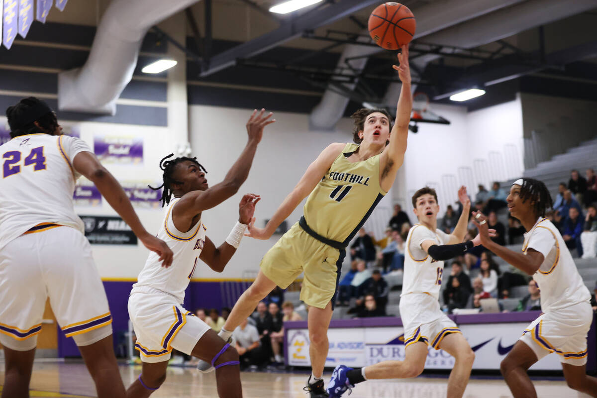 Foothill's Zak Abdalla (11) takes a shot under pressure from Durango's Tylen Riley (10) during ...