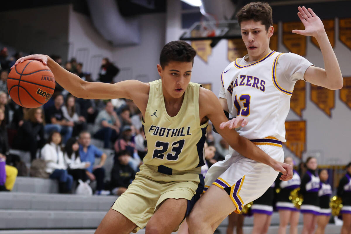 Durango's Colton Knoll (13) defends against Foothill's Shawn Salazar (23) during a boy's basket ...