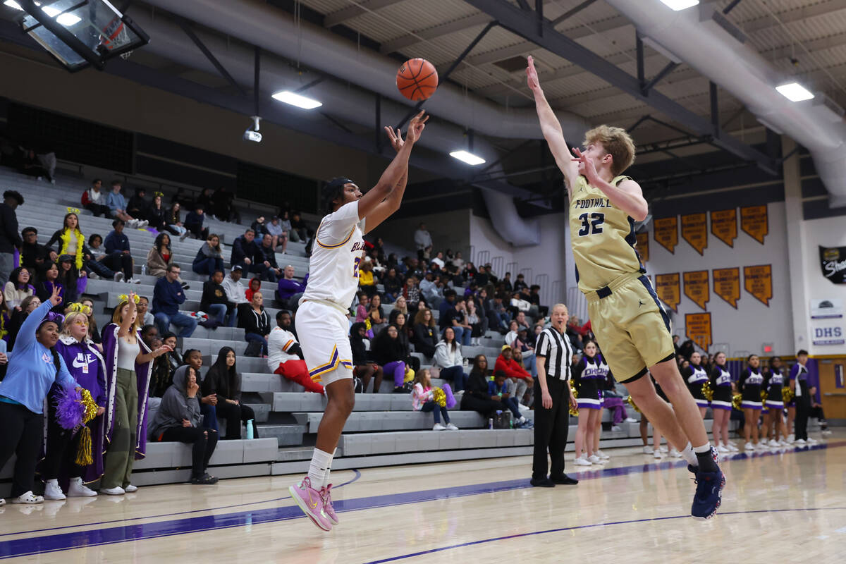 Durango's Taj Degourville (24) takes a 3-point-shot for a score under pressure from Foothill's ...