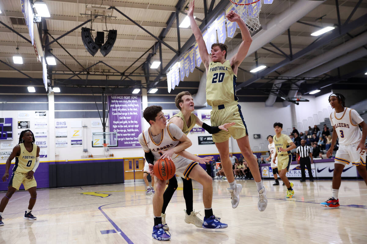 Durango's Tylen Riley (13) looks for an open play under pressure from Foothill's Christopher Na ...