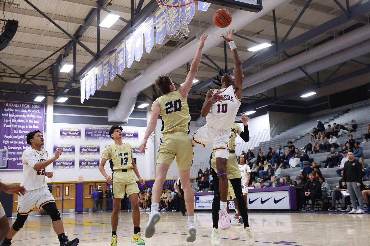 Durango's Tylen Riley (10) takes a shot under pressure from Foothill's Brock Stearman (20) duri ...