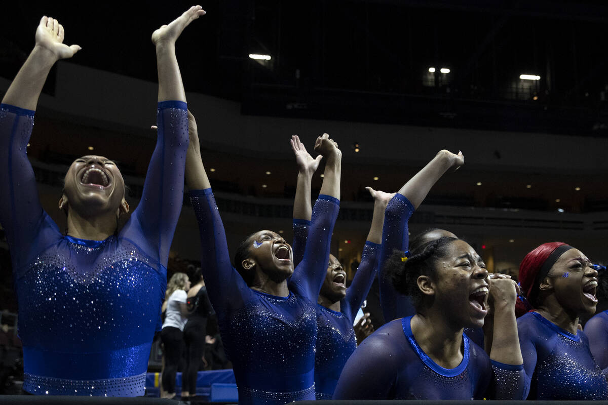Fisk University gymnasts cheer for Naimah Muhammed as she competes in floor exercise during ses ...