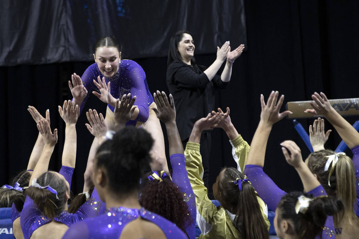 Skylar Killough-Wilhelm, University of Washington, is congratulated by her team after competing ...