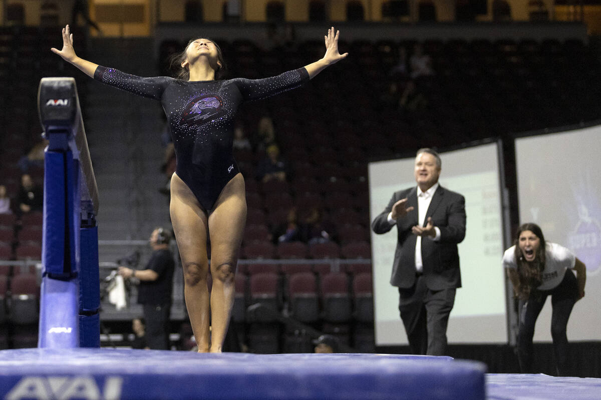 Shylen Murakami, Southern Utah University, sticks her landing after competing in balance beam w ...