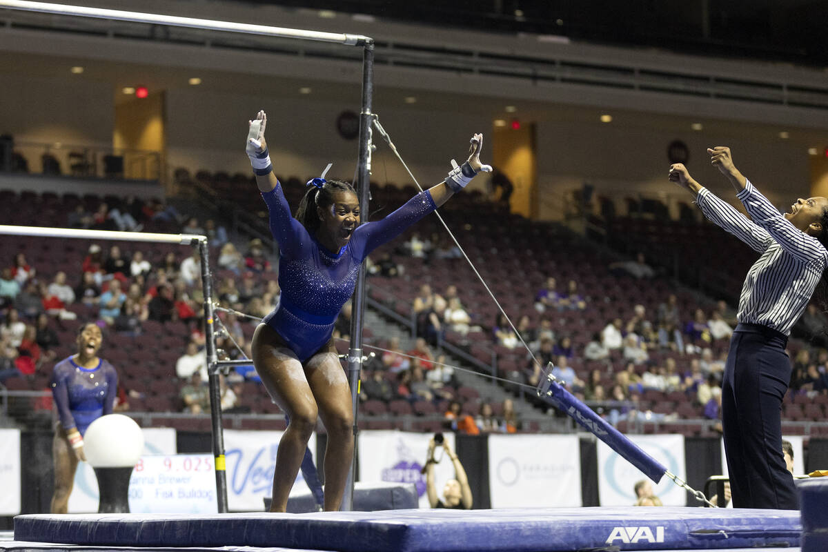 Morgan Price, Fisk University, celebrates while she sticks her landing in uneven bars during se ...