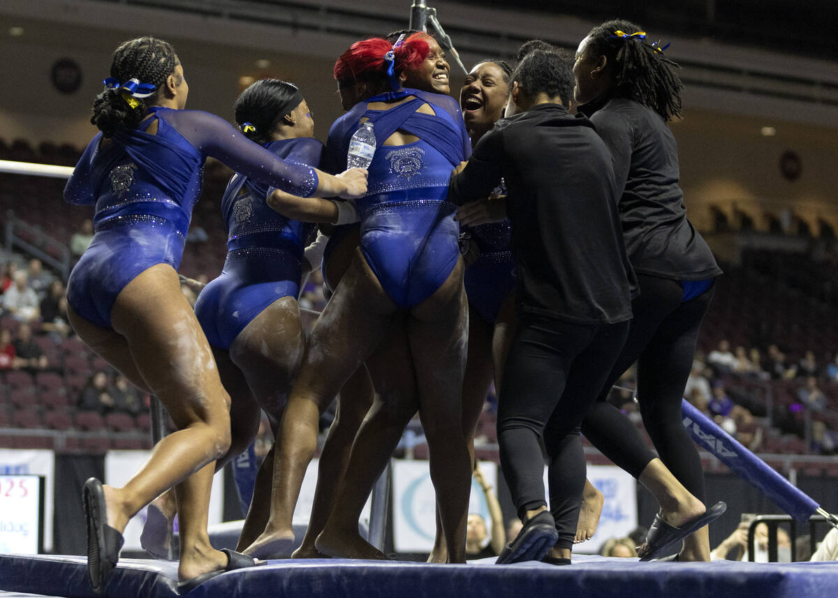 Fisk University team members surround Morgan Price after she competed in uneven bars during ses ...