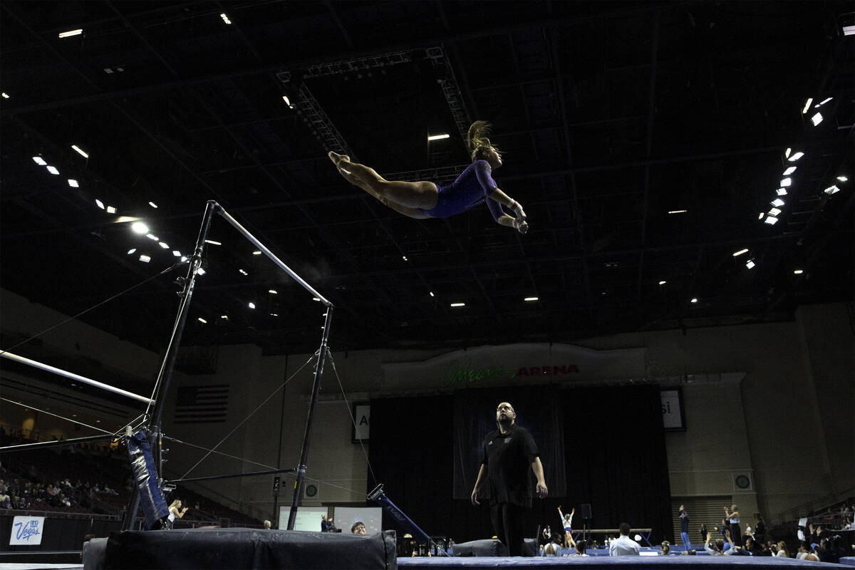 Lilly Tubbs, University of Washington, performs uneven bars during session one of the Super 16 ...