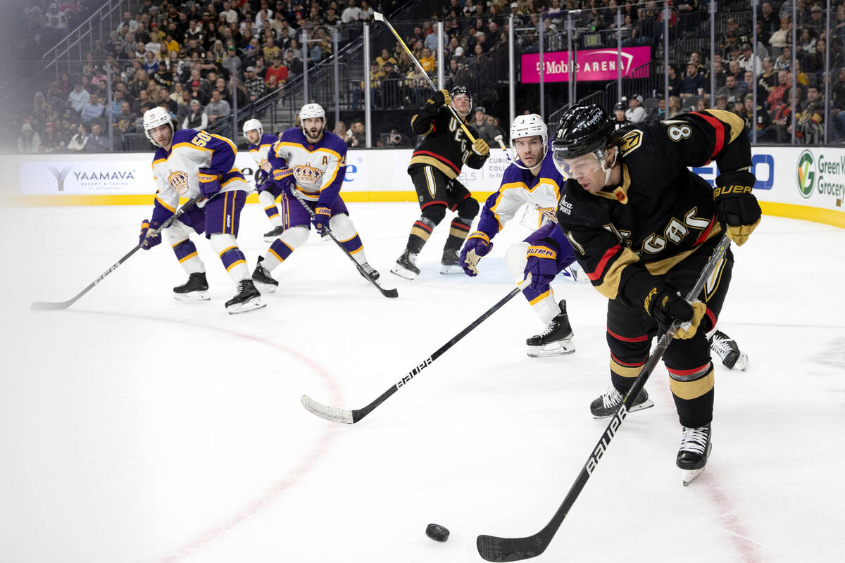 Vegas Golden Knights center Jonathan Marchessault, right, passes the puck while Los Angeles Kin ...