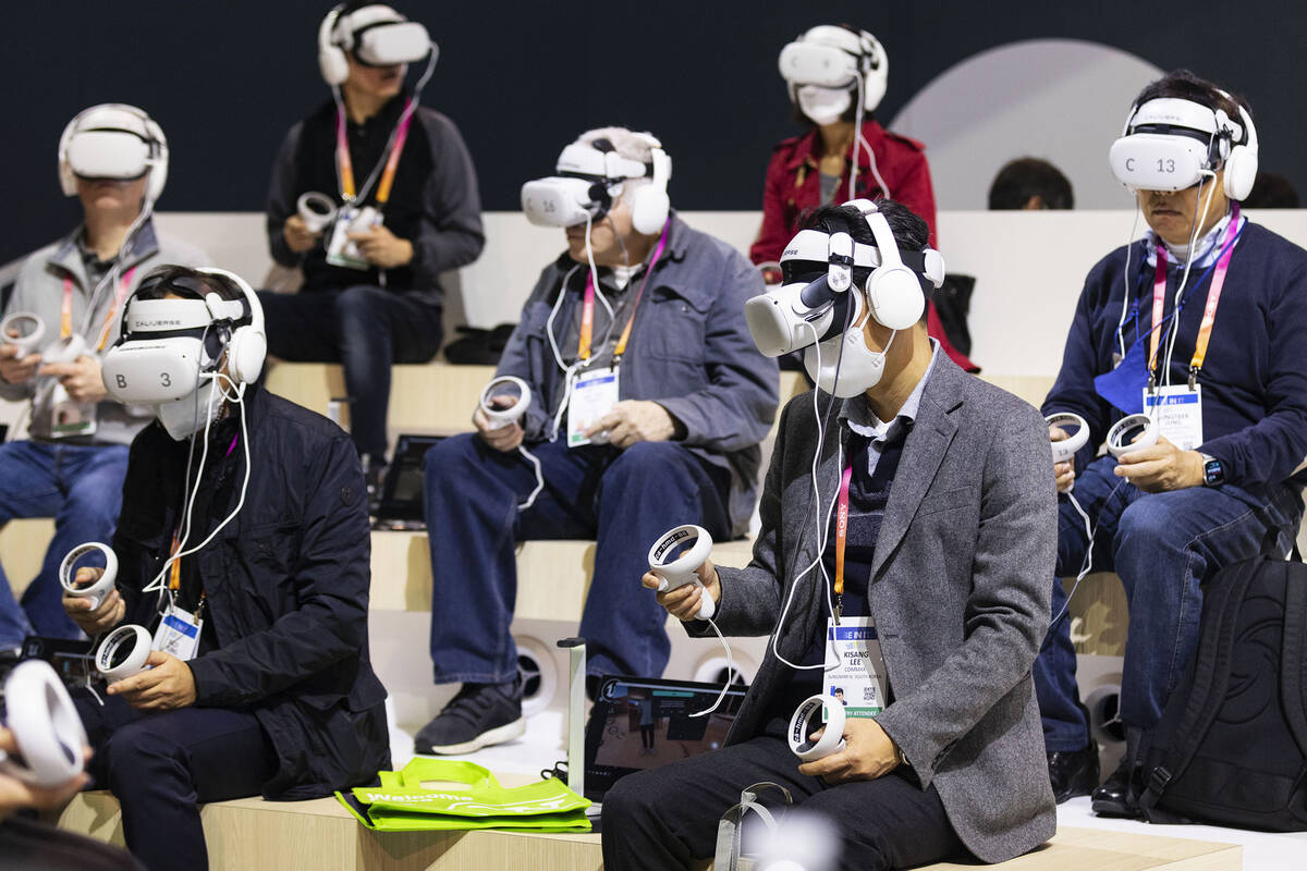 Conventiongoers experience LOTTE's VR googles during the CES 2023 at the Las Vegas Convention C ...