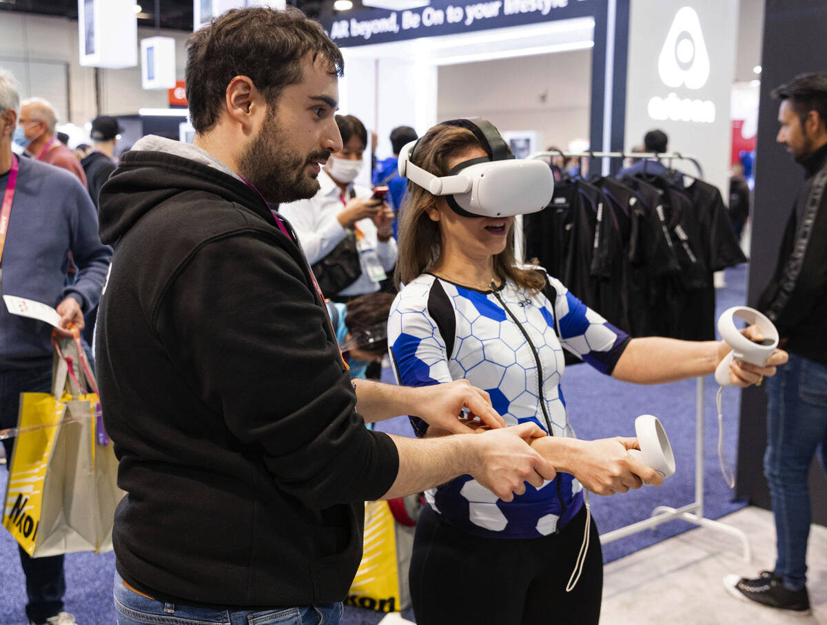 Adrian BeRnet of OWO demonstrates to Hannah Polikov how a shooting game with the use of OWO's V ...