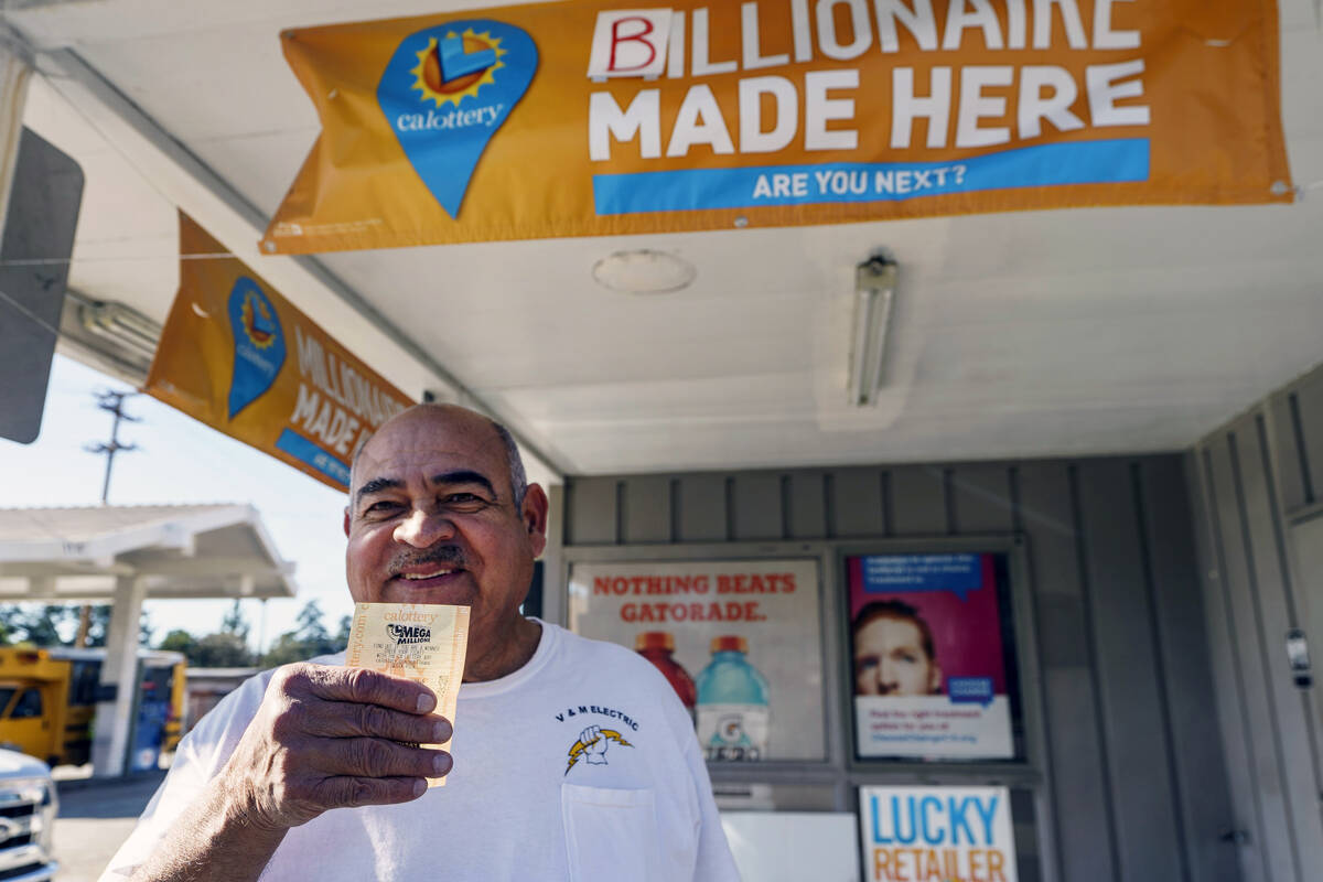 Electrician Jose Valles, 59, from Rancho Cucamonga, Calif., buys a SuperLotto Plus ticket at th ...