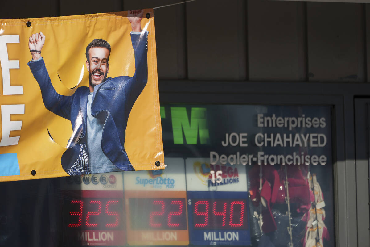 A sign for the estimated $940 million jackpot up for grabs is seen at Joe's Service Center, a M ...
