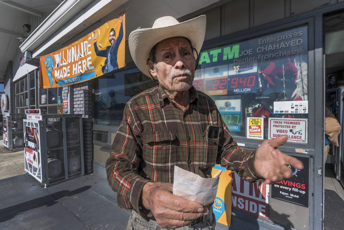 Roberto Ramirez, 77, from Guadalajara, Mexico holds a SuperLotto Plus ticket at the gas station ...