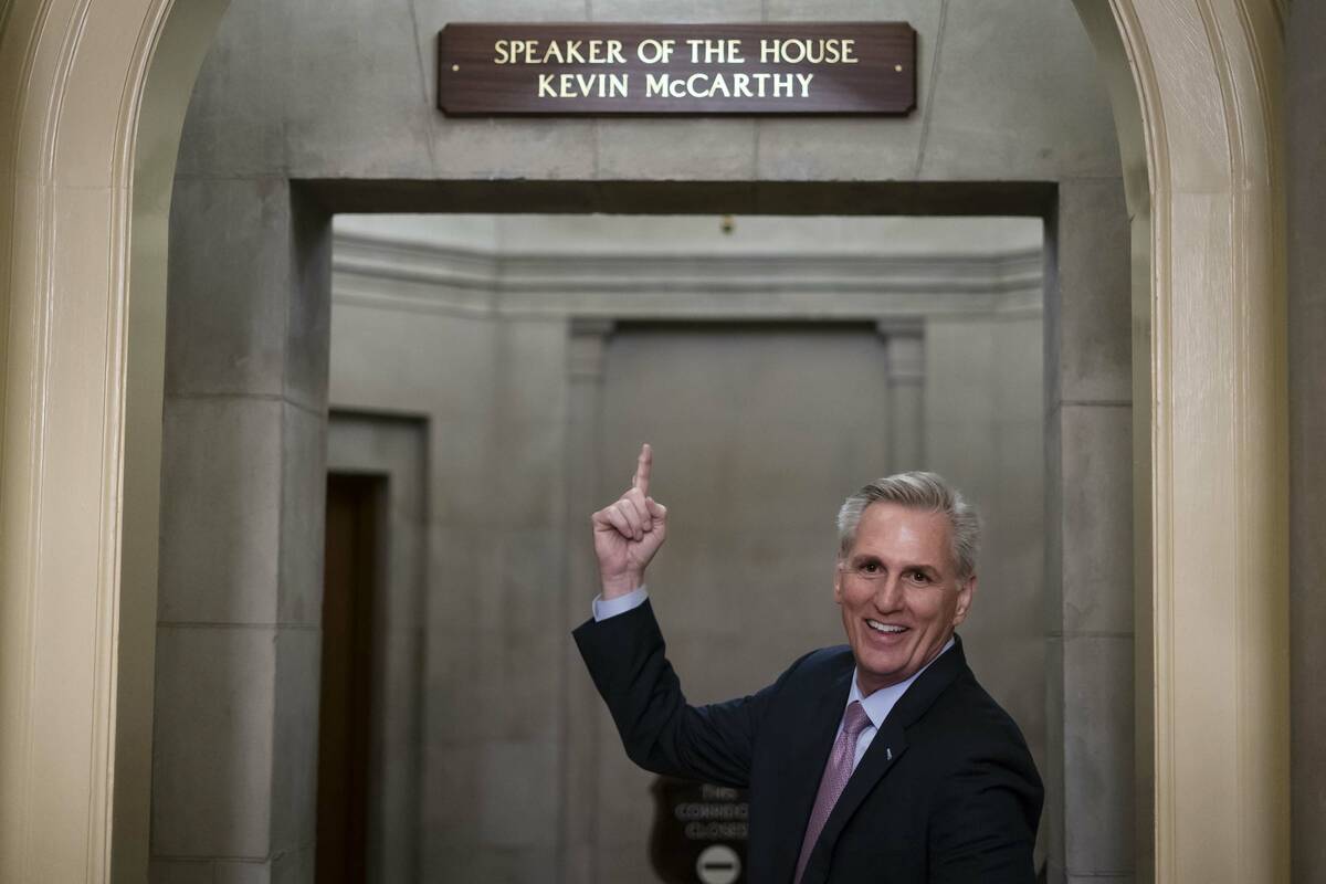 House Speaker Kevin McCarthy of Calif., gestures towards the newly installed nameplate at his o ...