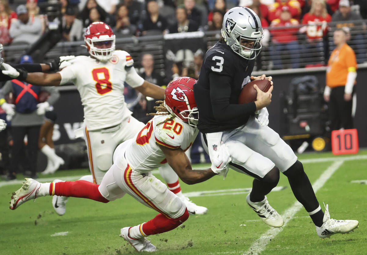 Raiders quarterback Jarrett Stidham (3) gets tackled by Kansas City Chiefs safety Justin Reid ( ...