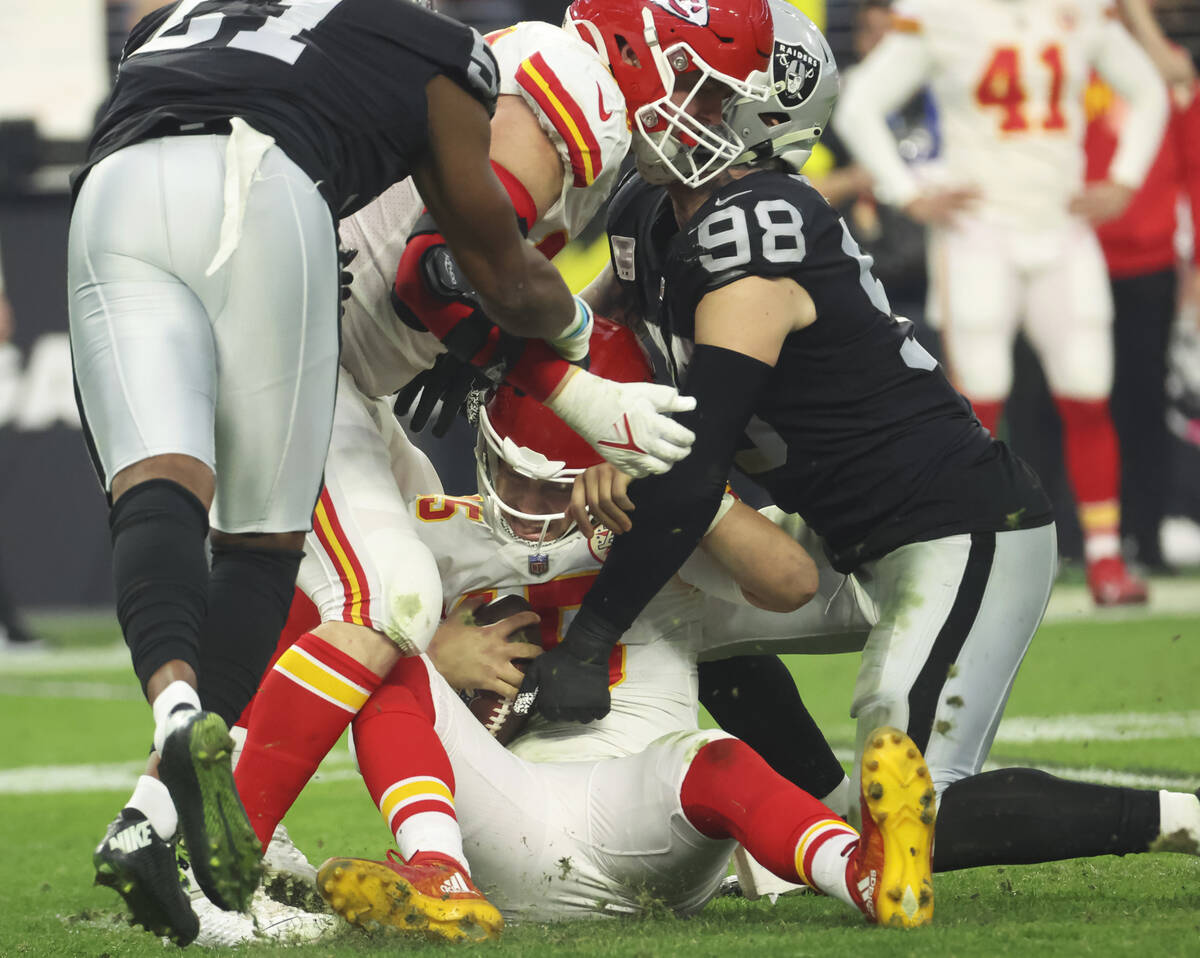 Kansas City Chiefs quarterback Patrick Mahomes (15) gets sacked by Raiders defensive end Maxx C ...