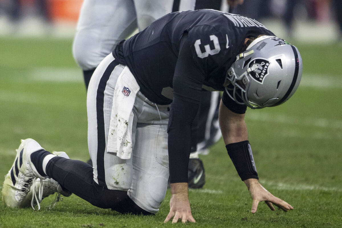 Raiders quarterback Jarrett Stidham (3) is slow to get up after being sacked during the second ...