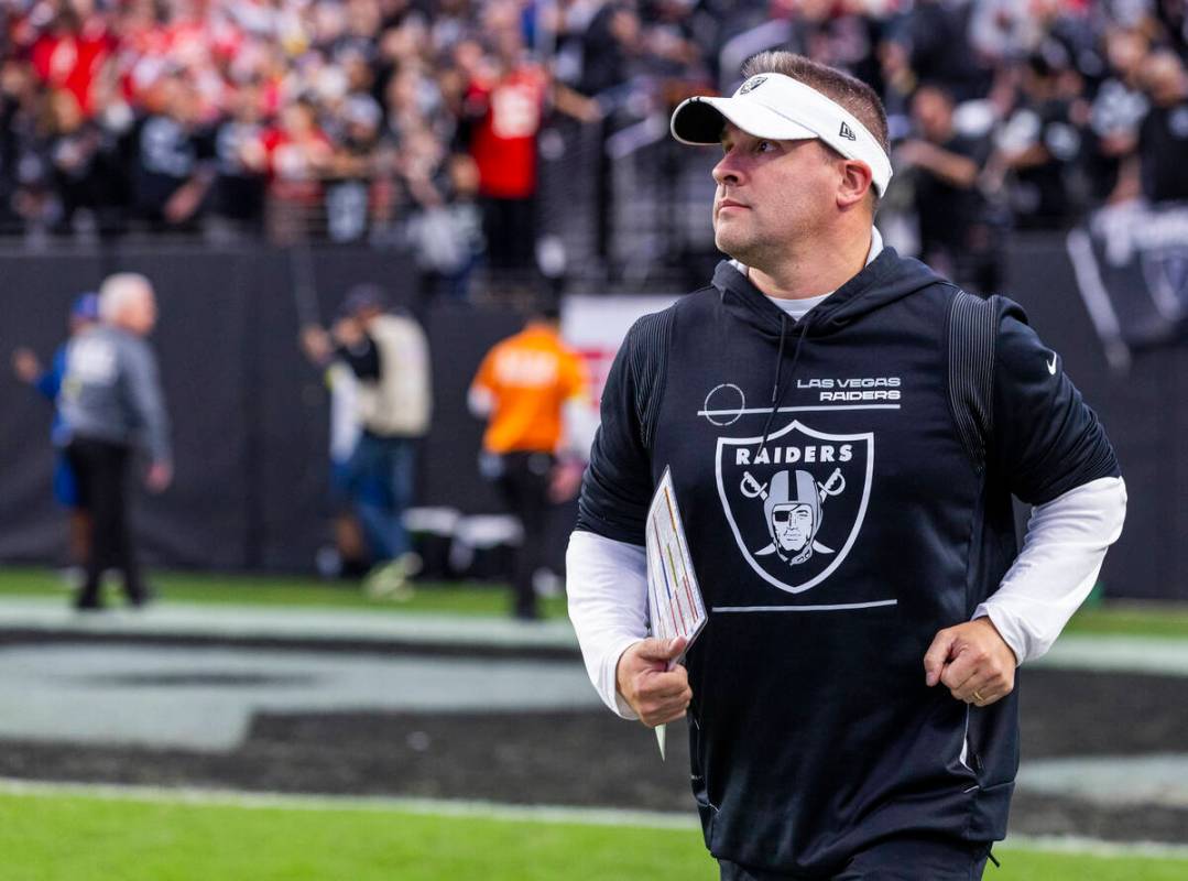Raiders Head Coach Josh McDaniels runs onto the field to face the Kansas City Chiefs during the ...