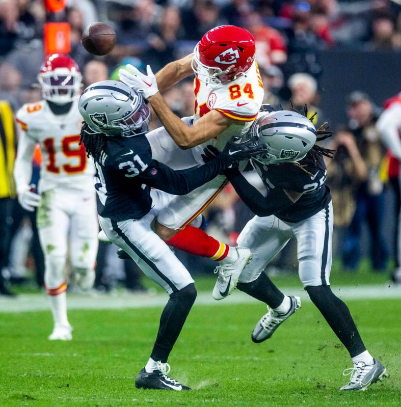 Raiders cornerback Sidney Jones IV (31) and safety Tre'von Moehrig (25) team cup to break up a ...