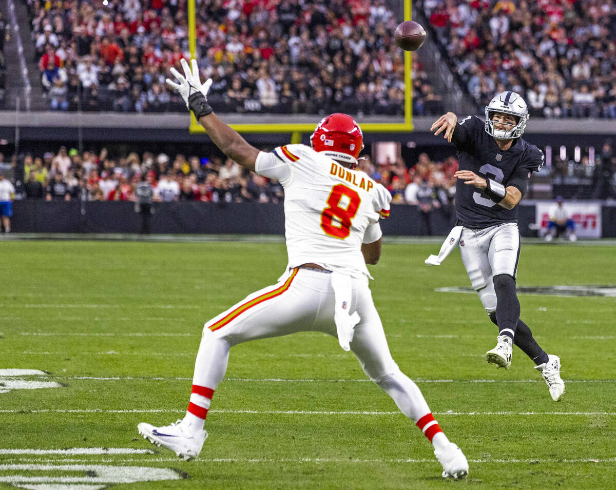 Raiders quarterback Jarrett Stidham (3) slings a pass past Kansas City Chiefs defensive end Car ...