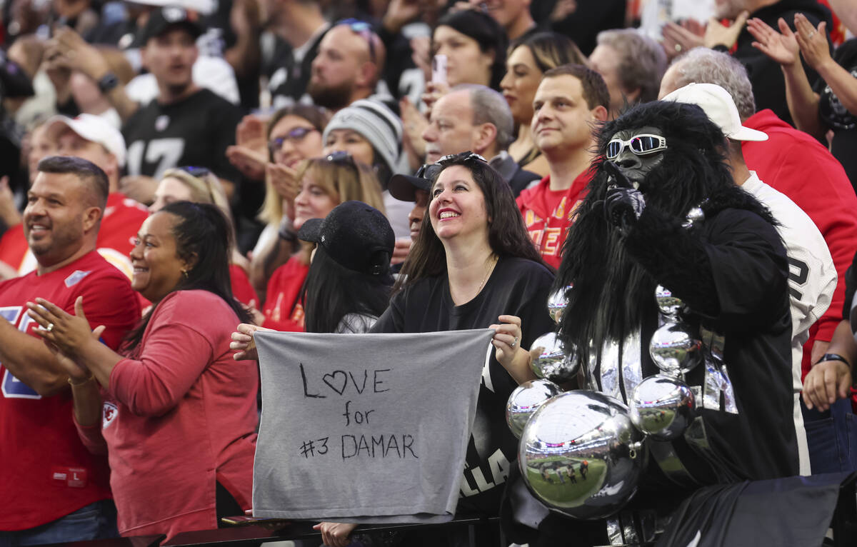 A Raiders fans holds up a sign in support of Buffalo Bills’ Damar Hamlin before an NFL g ...