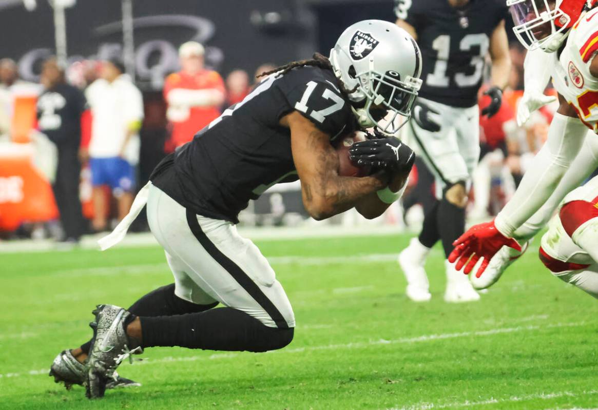 Raiders wide receiver Davante Adams (17) carries the ball against the Kansas City Chiefs during ...