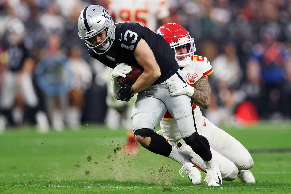 Las Vegas Raiders wide receiver Hunter Renfrow (13) is tackled by Kansas City Chiefs cornerback ...