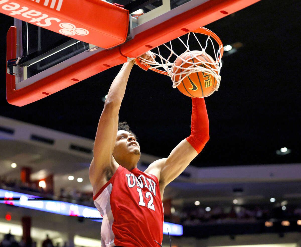 UNLV's David Muoka dunks against New Mexico during the first half of an NCAA college basketball ...