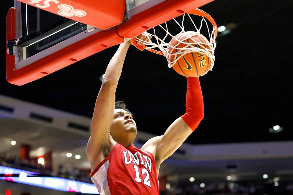 UNLV's David Muoka dunks against New Mexico during the first half of an NCAA college basketball ...