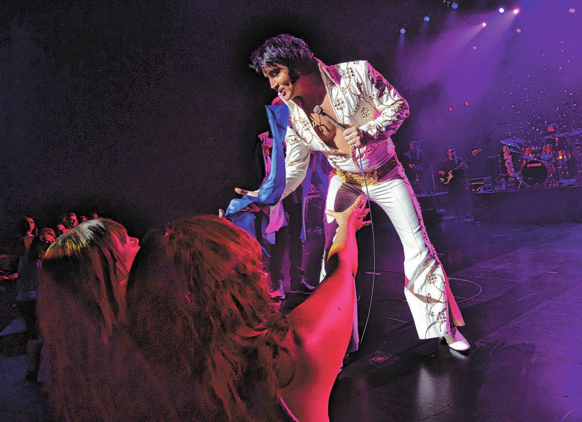 FILE - Elvis tribute artist Bill Cherry hands out scarfs to fans during the The King of Las Veg ...