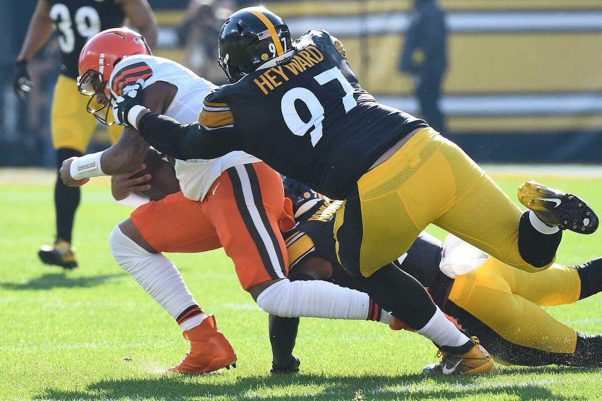 Cleveland Browns quarterback Deshaun Watson, left, is tackled by Pittsburgh Steelers defensive ...